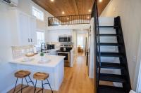 eine Küche mit einer Treppe, die zu einem Loft führt in der Unterkunft Tiny home Fire Pit Fishing Pond BBQ Sage Cabin in Gatlinburg