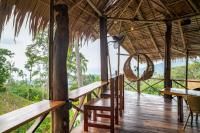 een veranda van een hut met een tafel en stoelen bij RoomQuest THEVA Resort Koh Samui in Koh Samui 
