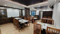 a dining room with wooden tables and chairs at Hotel Akshaya in Port Blair