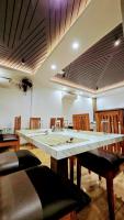 a dining room with a large table and chairs at Hotel Akshaya in Port Blair
