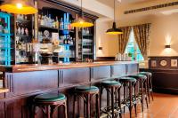アッシュハイムにあるHotel SchreiberHofの部屋の中にスツールが並んだバー