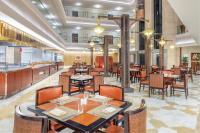 a dining room with tables and chairs and a restaurant at Marriott Hotel Jabal Omar Makkah in Makkah