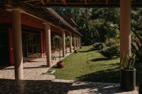 a courtyard of a building with grass and plants at Hotel Boutique Finca La Niebla in Coatepec