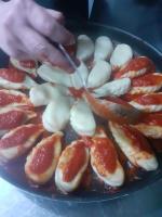 a person is preparing a plate of food at Podere Cerciano in Radicondoli