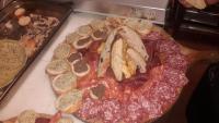 a pizza with different types of food on a table at Podere Cerciano in Radicondoli