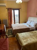 A bed or beds in a room at Hotel Aoos