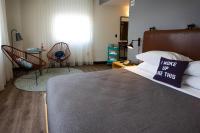 a bedroom with a bed with a sign on it at MOXY New Orleans Downtown/French Quarter Area in New Orleans