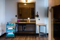a bathroom with a sink and a mirror and a stool at MOXY New Orleans Downtown/French Quarter Area in New Orleans
