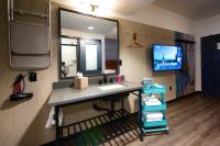 a bathroom with a sink and a large mirror at MOXY New Orleans Downtown/French Quarter Area in New Orleans