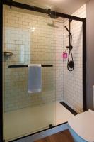 a shower with a glass door in a bathroom at MOXY New Orleans Downtown/French Quarter Area in New Orleans