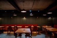an empty restaurant with tables and chairs and lights at Gоderdzi Twins Hotel in Goderdzi