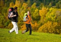 two people walking in a grassy field at Gasthof Holländer Eck in Lennestadt