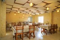 a restaurant with tables and chairs in a room at Virgin Valley Leisure Resort in Ooty