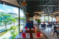 Beverly Hill Ha Long Villas and Apartments في ها لونغ: مطعم بطاولات وكراسي ونافذة كبيرة