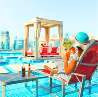 two people sitting in a chair next to a pool at Canal Central Hotel Business Bay in Dubai