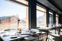 a row of tables in a restaurant with windows at SWISSPEAK Resorts Thyon 4 Vallées in Hérémence
