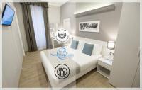 a hotel room with a bed with a sign on it at Nuovo Albergo Centro in Trieste
