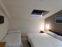 Postel nebo postele na pokoji v ubytování Hotel Villa De Pinto