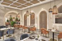 a rendering of a restaurant with tables and chairs at Grand Millennium Business Bay in Dubai