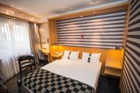 a hotel room with a bed and a window at Holiday Inn Vienna City by IHG in Vienna