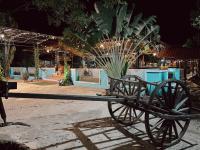 a park bench sitting in front of a building at Coconut Village Guesthouse and Bungalow in Kep