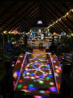 a room with a long table with colorful lights at Coconut Village Guesthouse and Bungalow in Kep