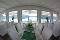 a dining room with a long table and white chairs at Strandhaus Edersee Nr 12 - Kaminzimmer, Seeblick, Badestrand, Seeterrasse in Waldeck