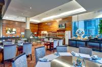 a restaurant with tables and chairs and a bar at Pearl Continental Hotel, Muzaffarabad in Muzaffarabad