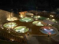 a group of three pools at night with umbrellas at Uni-Resort Ku-Kuan in Heping