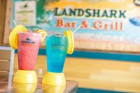 two cocktails in yellow and blue glasses on a table at Margaritaville Resort Cape Cod in Hyannis