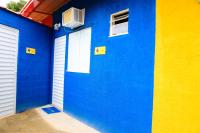 a blue building with two garage doors and windows at Pousada Mama África in Conservatória