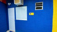 a blue building with a door and a window at Pousada Mama África in Conservatória