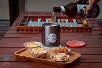 a beer is being poured into a can on a table at Laguna Pirangi Beach House in Parnamirim