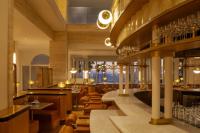 a restaurant with tables and chairs and a bar at Regent Santa Monica Beach in Los Angeles