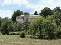 a building in the middle of a field with trees at La Grisonne - Chalet 3 in Revest-du-Bion