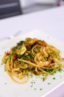 a plate of shrimp pasta on a white plate at Boca Beach Residence hotel in Boca Chica