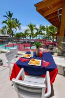 a table with a plate of food on a patio at Boca Beach Residence hotel in Boca Chica