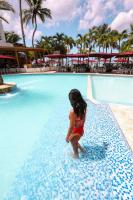 a young girl standing in the water at a swimming pool at Boca Beach Residence hotel in Boca Chica
