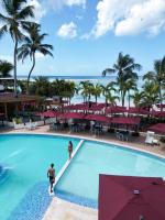 two people standing in a swimming pool at a resort at Boca Beach Residence hotel in Boca Chica