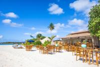 a beach with chairs and tables on the sand at The MAVERICK SURF AND DIVE BOUTIQUE HOTEL - Book 10 Nights and get 1 Free Night - Free Speed Boat Service - Kids Stay Free in Laamu