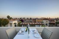 a table on a balcony with a view of the city at Riad Kheirredine in Marrakech