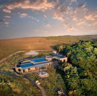 an aerial view of a house in the middle of a field at GweGwe Beach Lodge in Mkambati