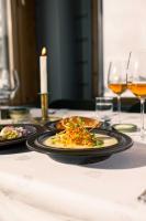 a table with two plates of food and a candle at Ski Resort & Hotel Pikku-Syöte in Syöte
