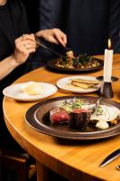 a person sitting at a table with plates of food at Ski Resort & Hotel Pikku-Syöte in Syöte