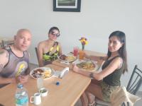 a group of people sitting at a table eating food at hotel el parral suite in Ica