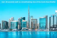 a view of a large city with a body of water at Canal Central Hotel Business Bay in Dubai