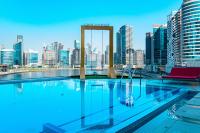 a swimming pool with a view of a city skyline at Canal Central Hotel Business Bay in Dubai