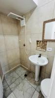 a bathroom with a sink and a toilet and a mirror at Hotel Nils in Itapoa