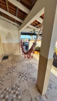 a porch with a hammock on a house at Hotel Nils in Itapoa