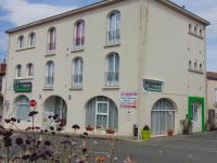 a large white building with many windows on a street at Résidence L&#39;Ogomé in Le Boupère